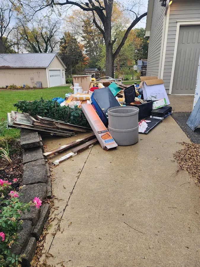 Dumpster being loaded with debris for 12 Yard Dumpster Rental in Henniker